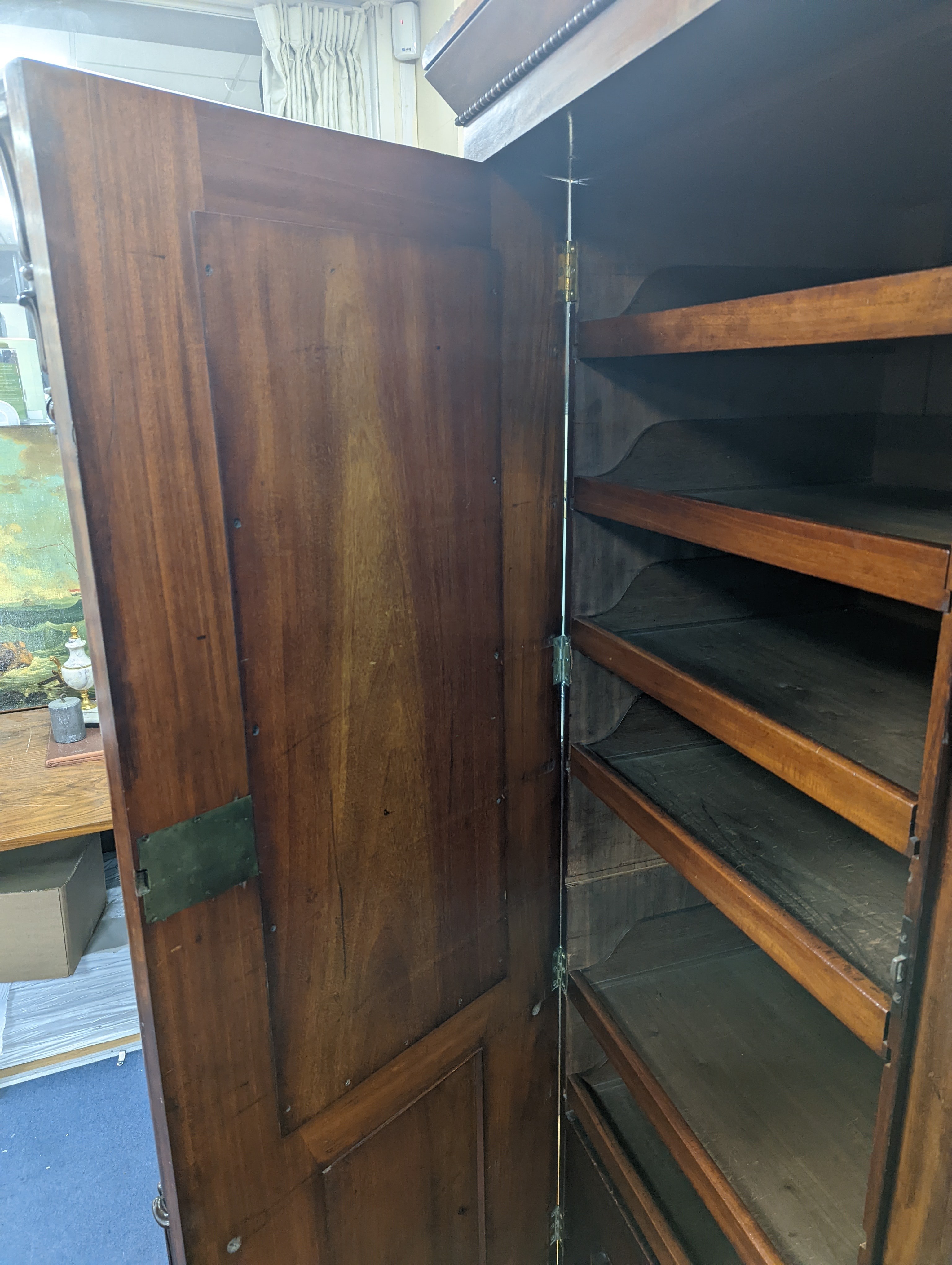 A William IV figured mahogany inverse breakfront compactum wardrobe, length 263cm, depth 70cm, height 197cm